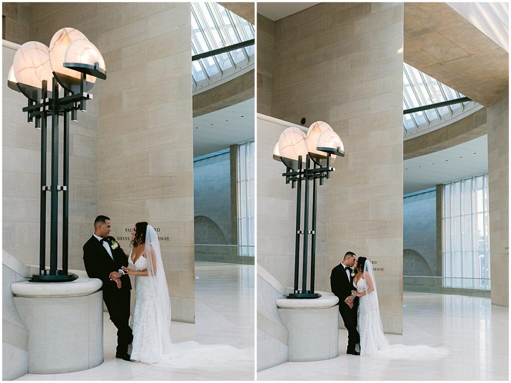 Bride and groom standing beneath lights at Dallas Meyerson Symphony Center Wedding