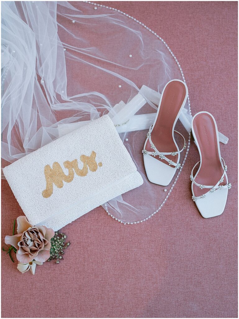 Wedding details including shoes, purse, veil and florals