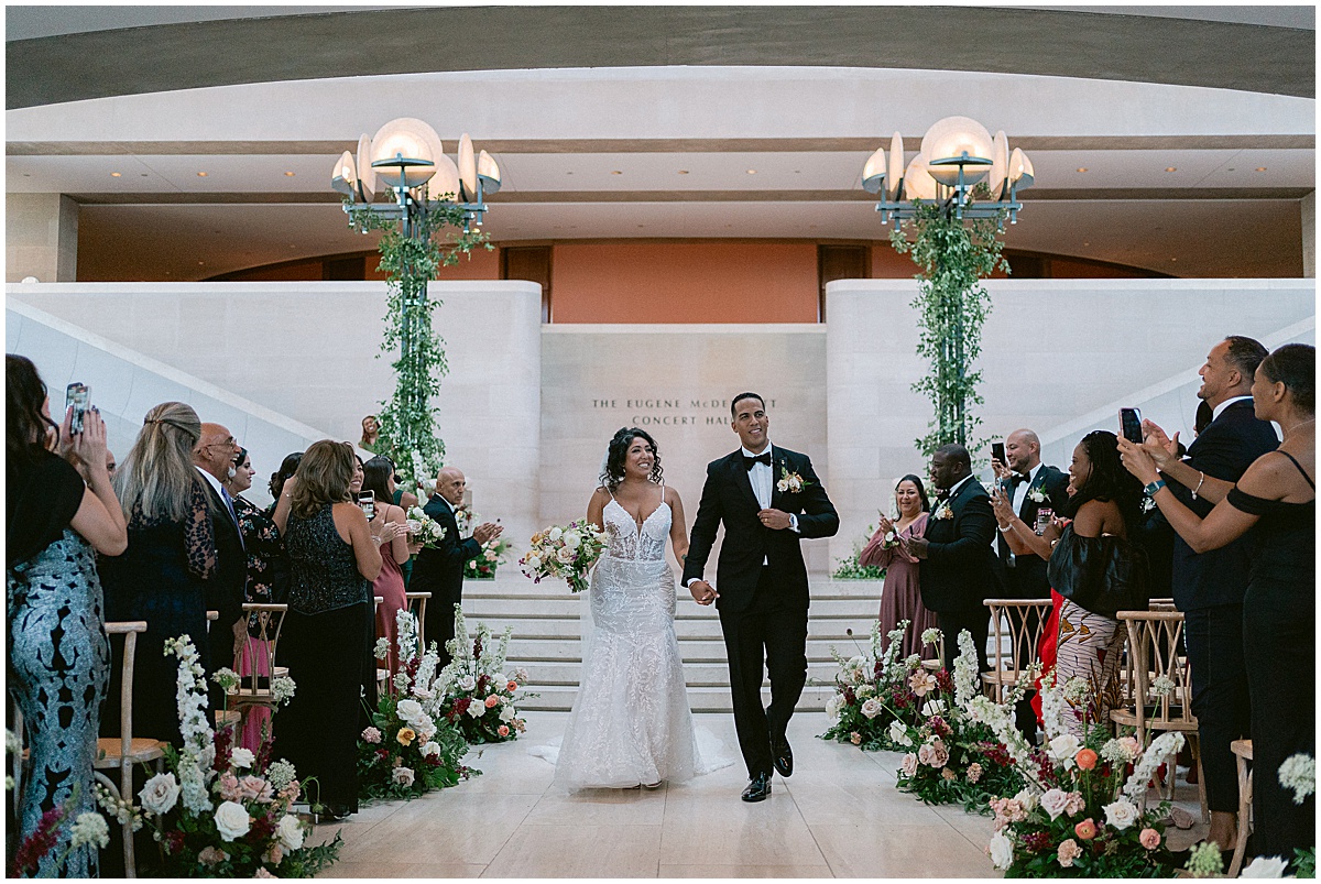 Bride and groom walking down the aisle after wedding at Dallas Meyerson Symphony Center