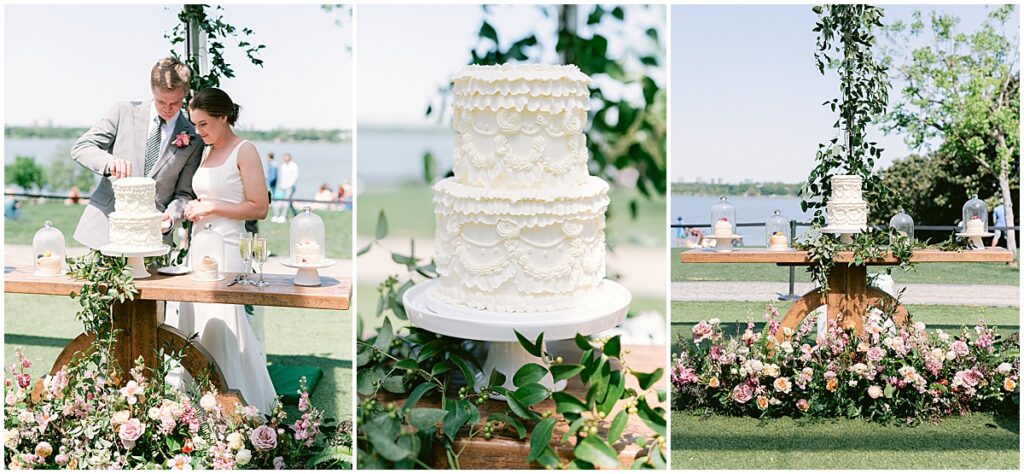 Wedding cake on wooden table surrounded by greenery and florals