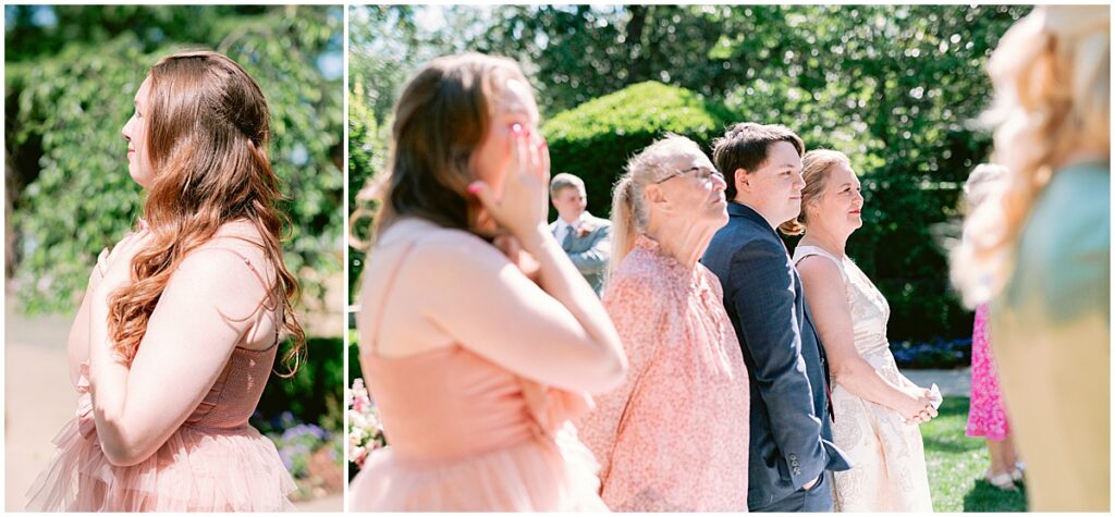Guests looking emotional as bride walks down the aisle at outdoor wedding ceremony