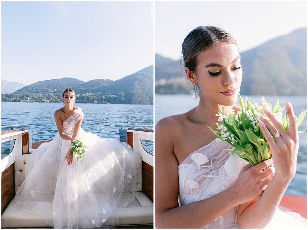 Bride wearing full lace wedding dress holding white and green florals on boat on Lake Como
